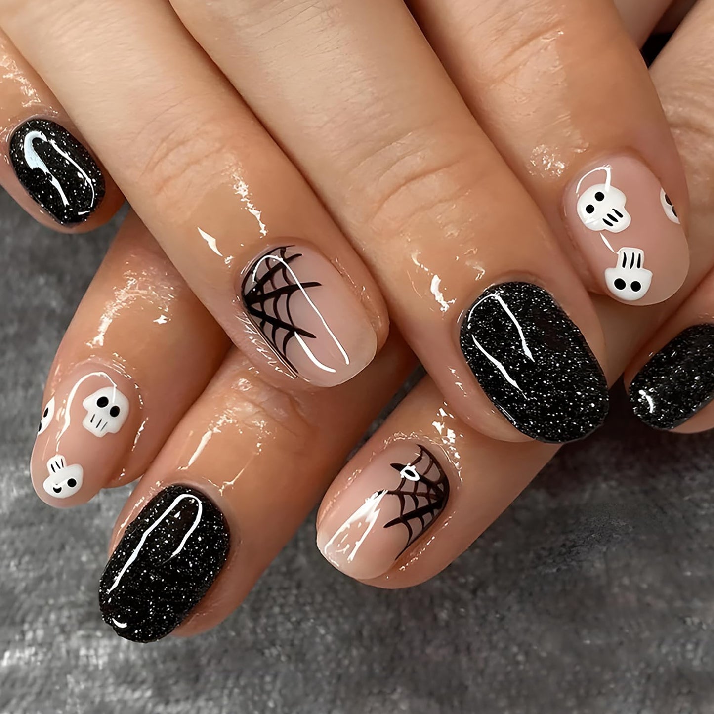 Halloween Press on Nails Black Glitter Fake Nails Short Glue on Nails with Spider Web Skull Design Round Head Almond Acrylic Nails Glossy Full Cover Stick on Nails for Women Halloween Nail Decorations