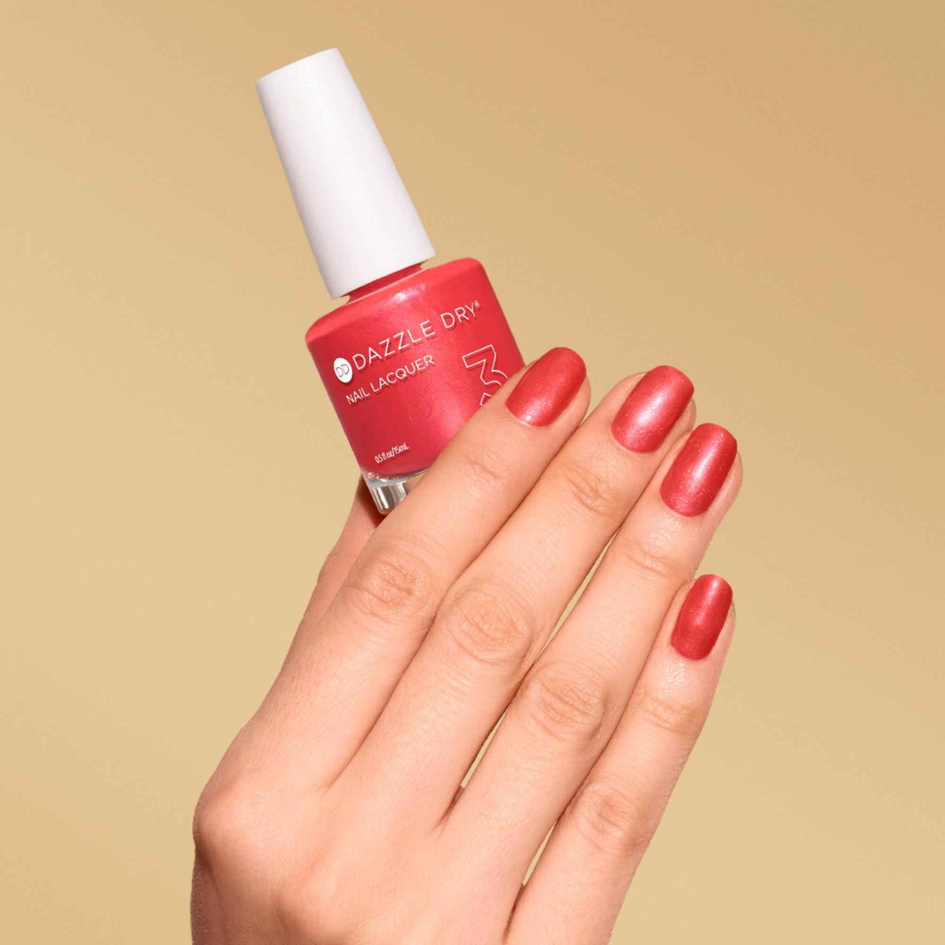 Dazzle Dry Nail Lacquer (Step 3) - Poolside Pink - A deep coral pink-red. Semi-sheer shimmer. (0.5 fl oz)