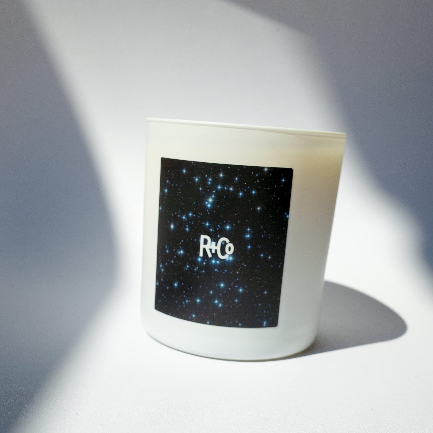 R+Co Stars Align Candle | Essence of Palo Santo + White Cedar Wood + Smoky Tobacco | Vegan + Cruelty-Free | 0.5 lb.